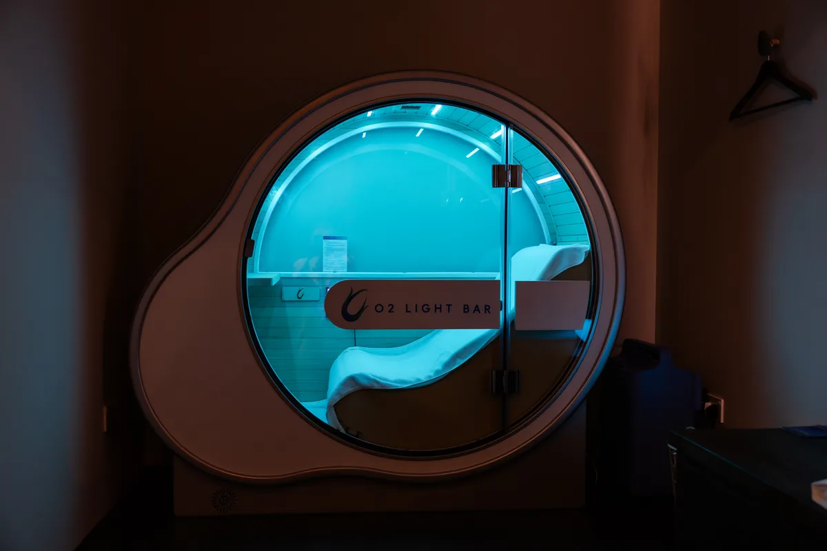 An O2 Oasis oxygen pod at O2 Light Bar, The Cathay, lit in soft teal