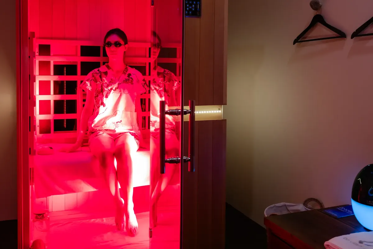 Guest in a Zen Cabin suite with red light at O2 Light Bar